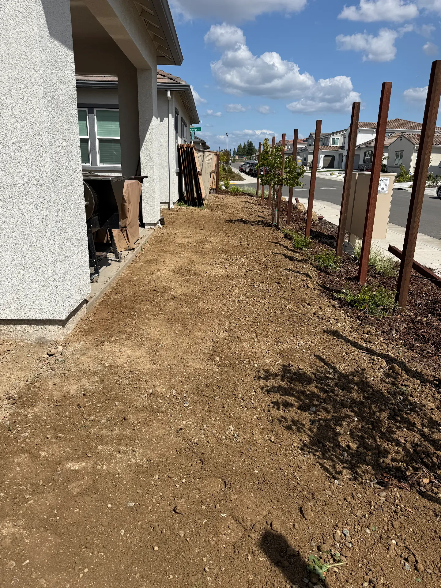 Prepared soil along the side of a residential property